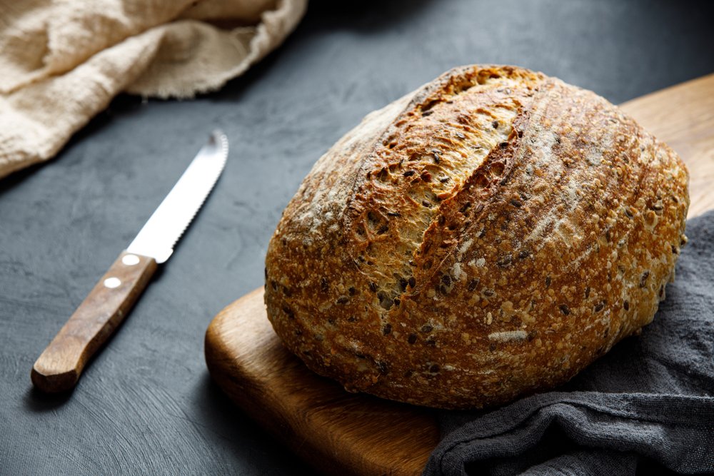 Round,Loaf,Of,Freshly,Baked,Sourdough,Bread,With,Knife,On