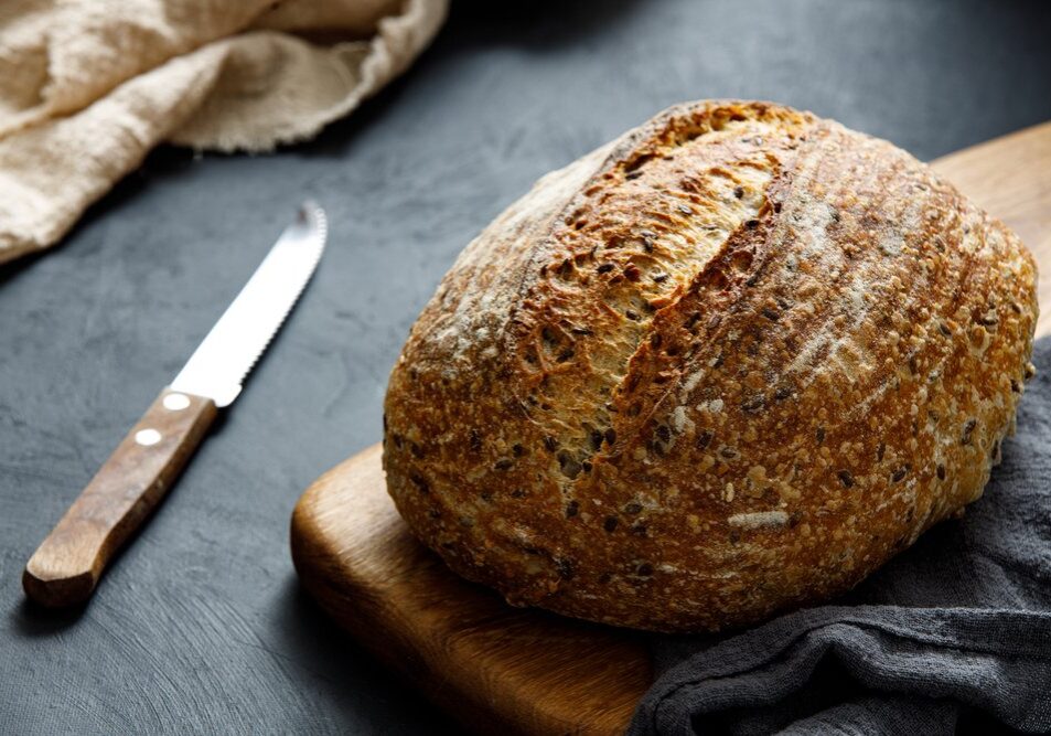 Round,Loaf,Of,Freshly,Baked,Sourdough,Bread,With,Knife,On